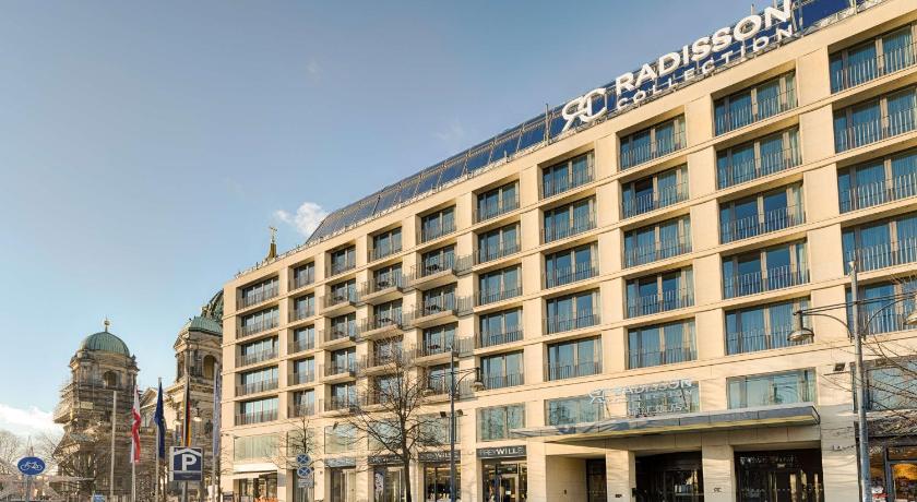 a large building with a clock on the front of it, Radisson Collection Hotel, Berlin in Berlin
