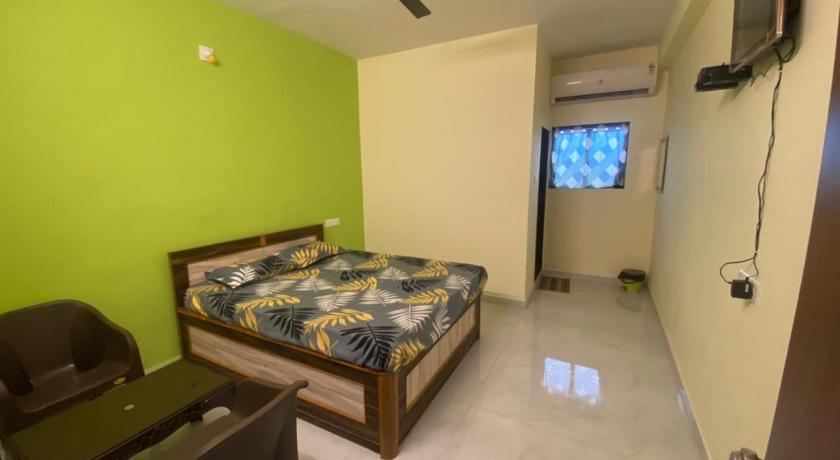 a bedroom with a bed and a television, ROYAL VILLA HOUSE in Daman