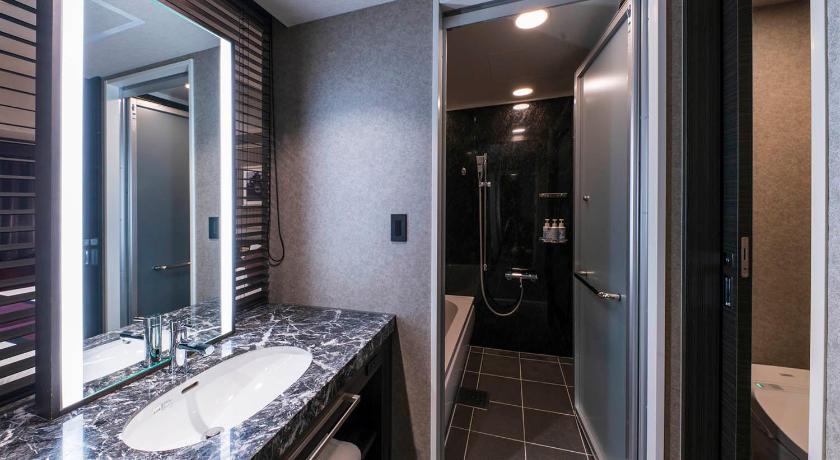 a bathroom with a shower, sink, and mirror, The Park Front Hotel at Universal Studios Japan in Osaka