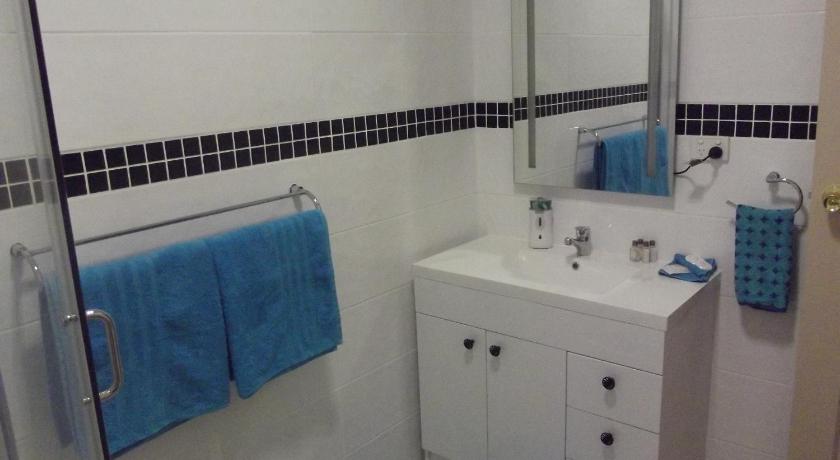 a bathroom with a white towel hanging on the wall, Muswellbrook Northside Bed & Breakfast in Muswellbrook