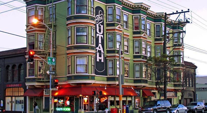 a city street with a tall brick building, The Utah Inn in San Francisco (CA)