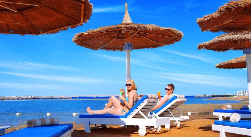 people sitting on top of a beach, Pickalbatros Alf Leila Wa Leila Resort - Neverland Hurghada in Hurghada