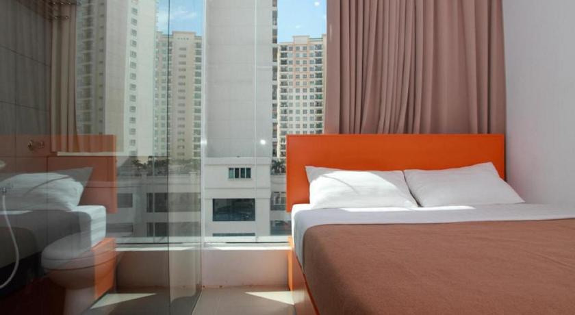 a hotel room with a large bed and a large window, 1 Hotel Kuchai Lama in Kuala Lumpur