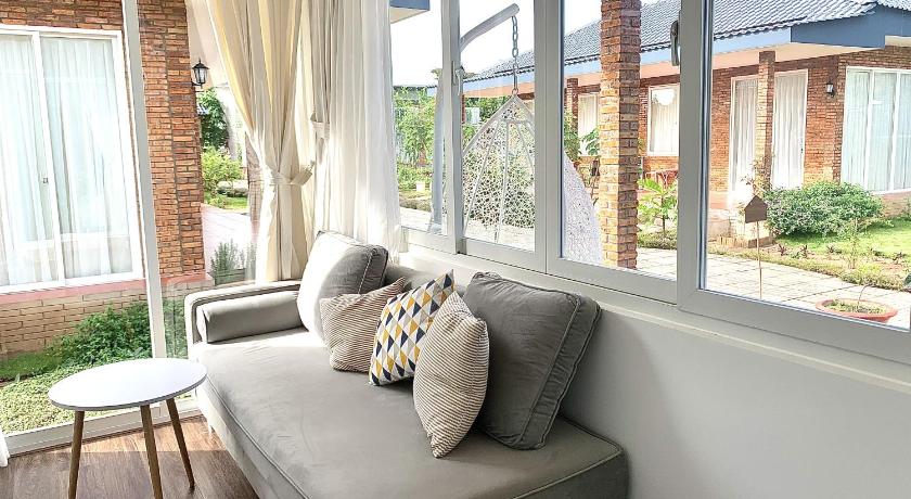 a white couch sitting in front of a window, Huyen's Home in Vung Tau