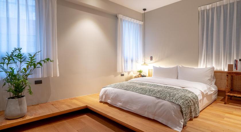 a bedroom with a large bed and a large window, OR Inn in Hsinchu