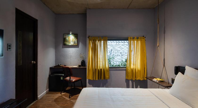 a bedroom with a bed and a window, The Note Dalat in Dalat