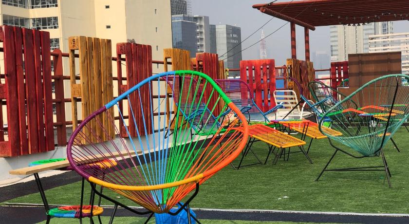a park filled with lots of lawn chairs and umbrellas, Casa Eufemia Hostel type in Mexico City