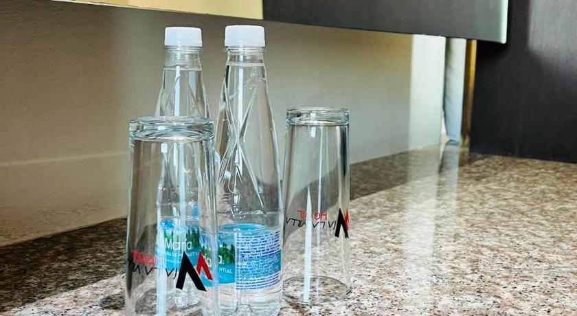 a bottle of water sitting on top of a counter, Hotel Via La Villa in Mexico City