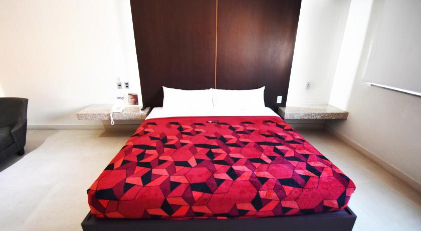 a bedroom with a bed and a dresser, Hotel Via La Villa in Mexico City