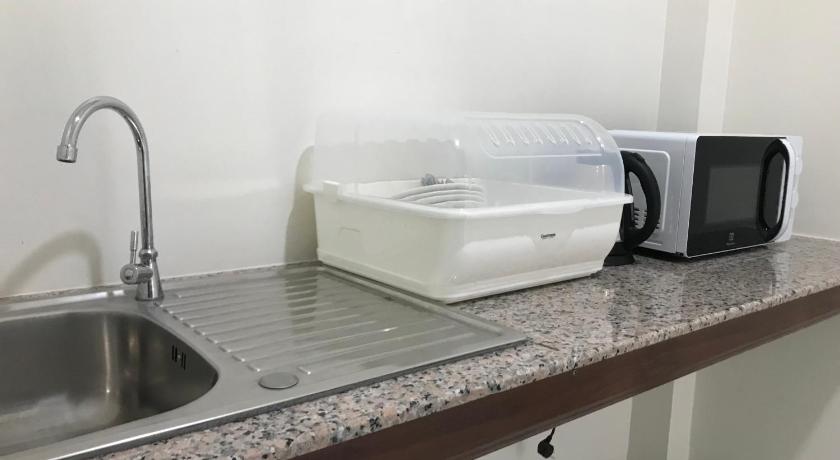 a white microwave sitting on top of a counter top, Park Villa Chaiyaphume in Chaiyaphum