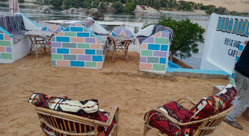 a table with chairs and a table cloth on it, Baba Dool in Aswan
