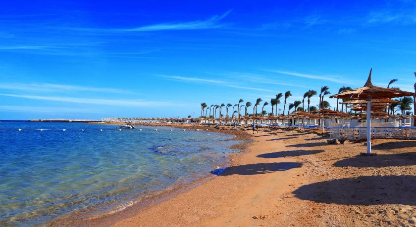 a sandy beach with palm trees and palm trees, Pickalbatros Alf Leila Wa Leila Resort - Neverland Hurghada in Hurghada