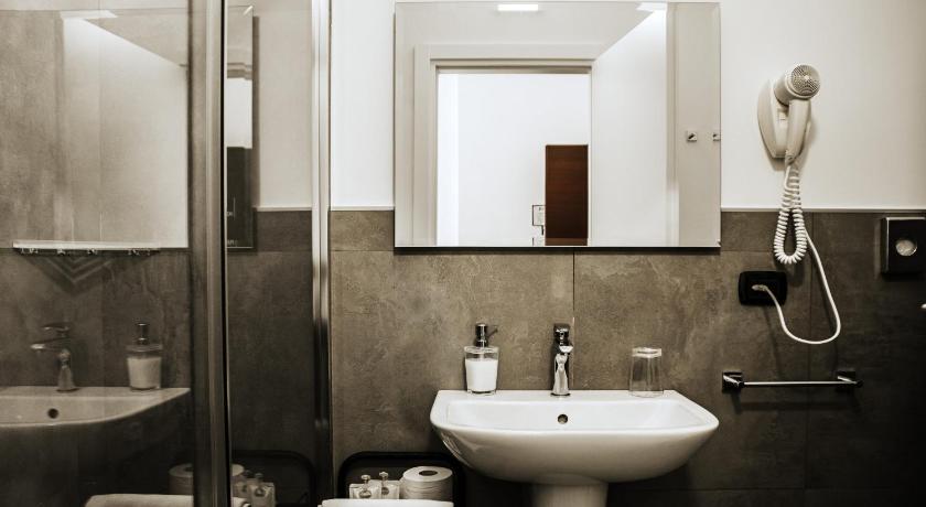 a bathroom with a sink and a mirror, Travel B&B in Bari