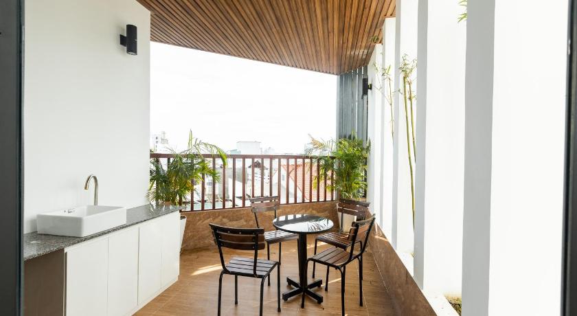 a dining room table with chairs and a patio, Sea Night Hotel in Phan Thiet