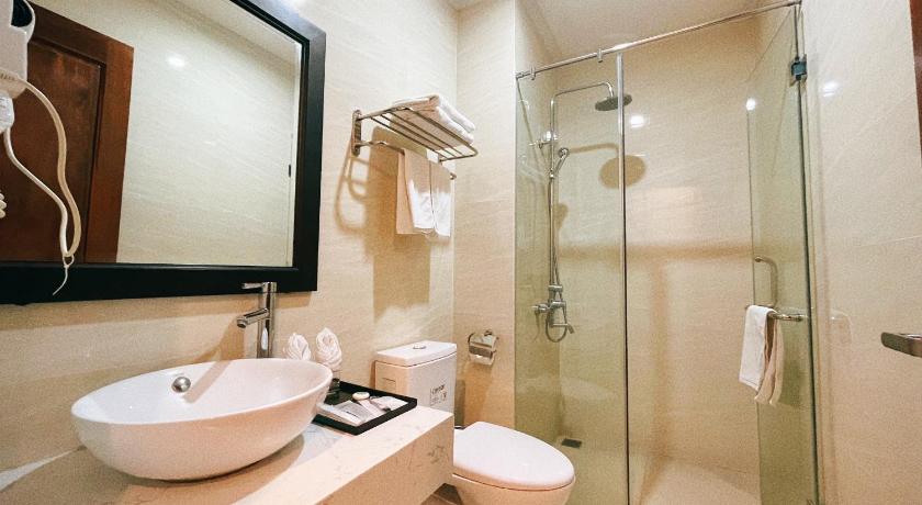 a bathroom with a shower, sink, and mirror, Paragon House and Residence in Hanoi