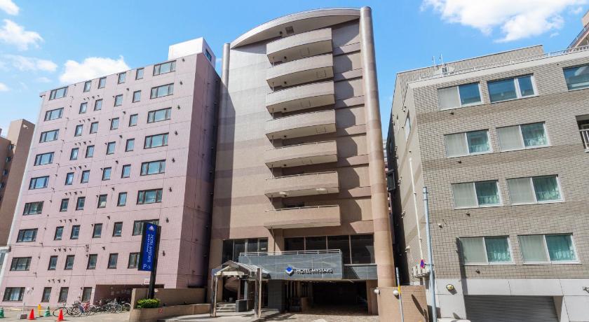 a large building with a large clock on the side of it, HOTEL MYSTAYS Sapporo Nakajima Park Annex in Sapporo