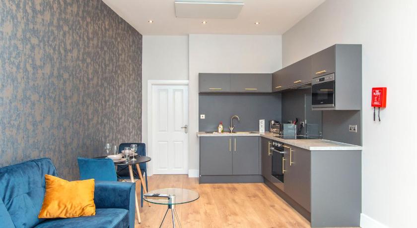 a living room filled with furniture and a kitchen, Coldharbour Suites in Bristol