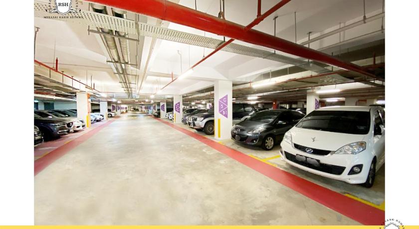 a car parked in a parking lot next to a building, Rasa Sayang Homestay at Bukit Jalil Pavilion in Kuala Lumpur