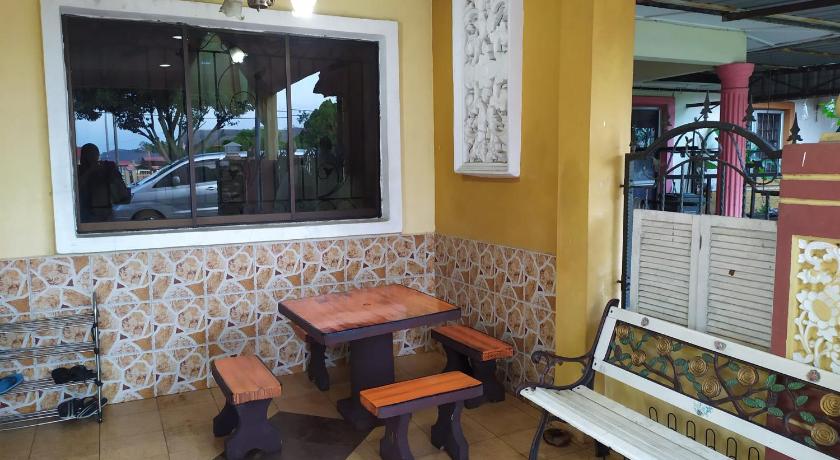 a wooden bench sitting in front of a large window, Homestay Mamasya Melaka in Malacca
