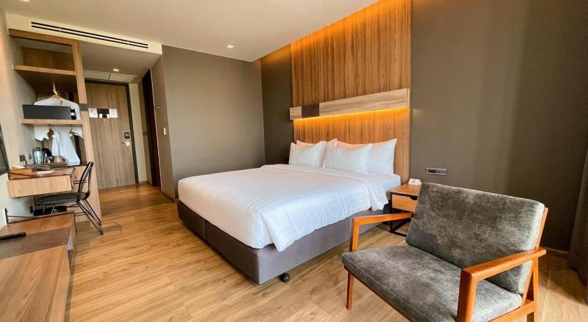 a bedroom with a bed and a chair, The Teak Hotel (SHA Extra Plus) in Tak