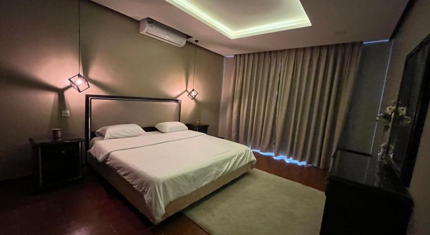 a bedroom with a bed and a lamp on the wall, درة العروس فان بيتش الخاصه in Jeddah
