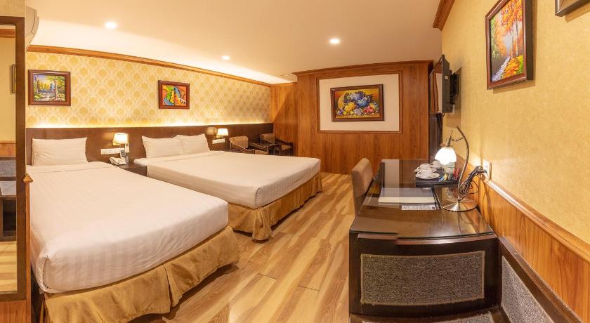 a hotel room with two beds and a television, Kings Hotel Dalat in Dalat