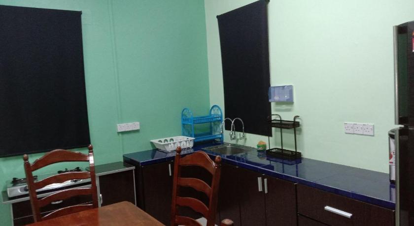 a room with two chairs and a desk, D'Merbok Homestay in Sungai Petani