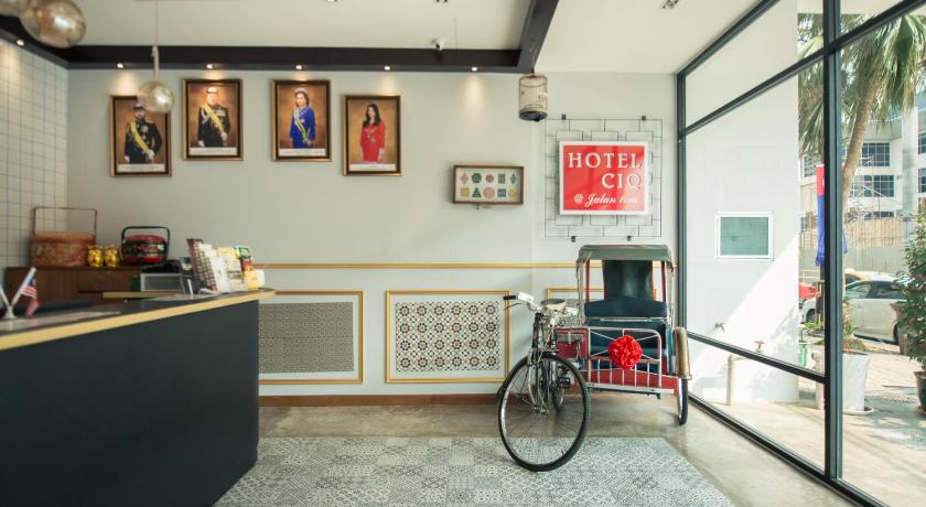 a room with a bicycle and a clock on the wall, Hotel CIQ @ Jalan Trus in Johor Bahru