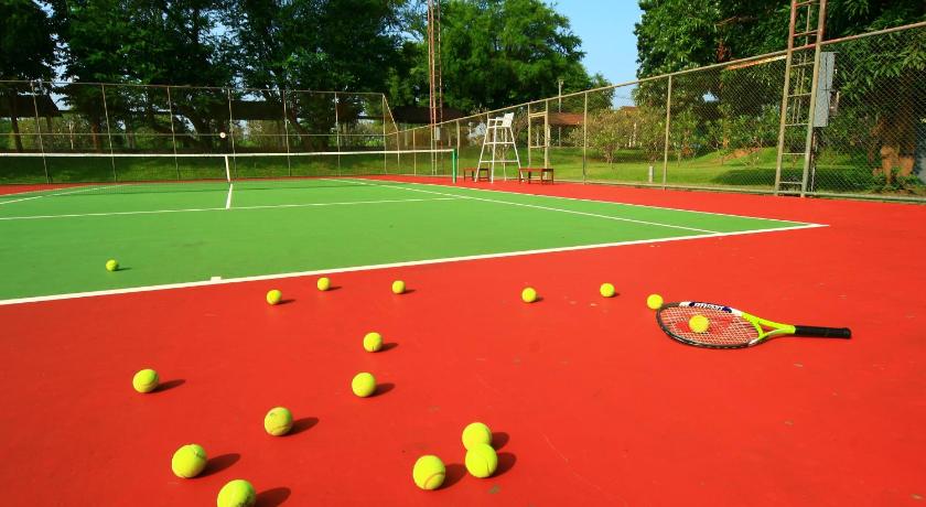 a tennis court with a tennis ball and racquet on it, Felix River Kwai Resort (SHA Plus+) in Kanchanaburi