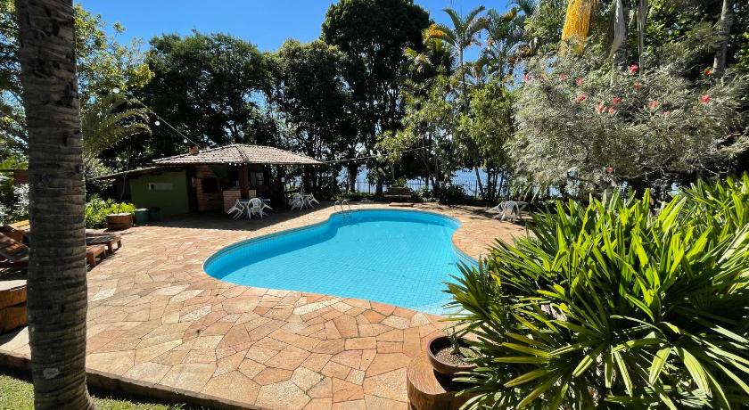a patio area with a pool and a pool table, Casa do Lago Hospedaria in Brasilia