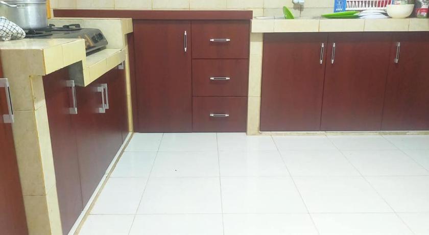 a kitchen with a sink, stove and cabinets, Blesshomestay Samosir in Samosir
