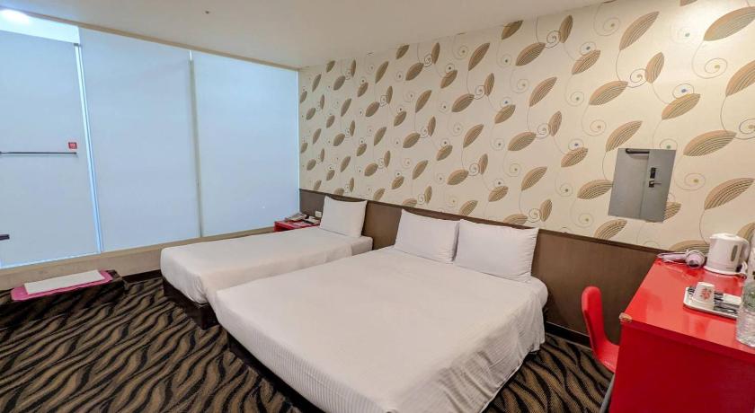 a hotel room with a bed and a dresser, LIHO Hotel Tainan in Tainan