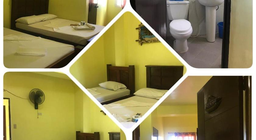 a bathroom with two beds and a mirror, Luis Bay Travellers Lodge in Palawan