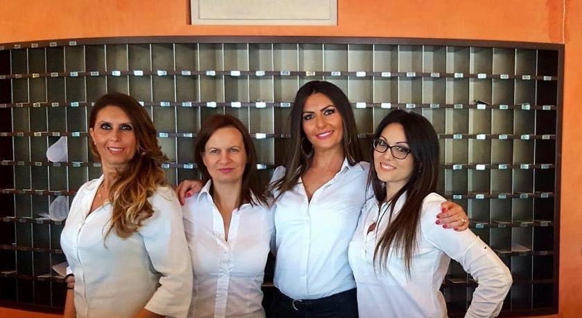 three women standing next to each other in front of a counter, Gran Paradiso Hotel Spa in San Giovanni Rotondo