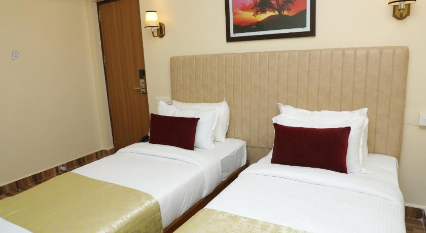 a hotel room with two beds and two lamps, Gadiraju Palace Convention Centre & Hotel in Visakhapatnam