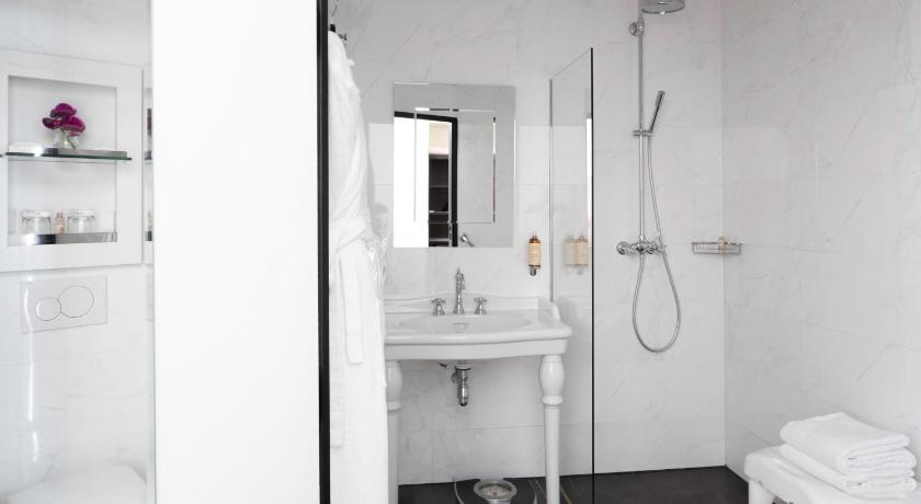 a bathroom with a shower, sink, and toilet, Le 123 Elysees - Astotel in Paris