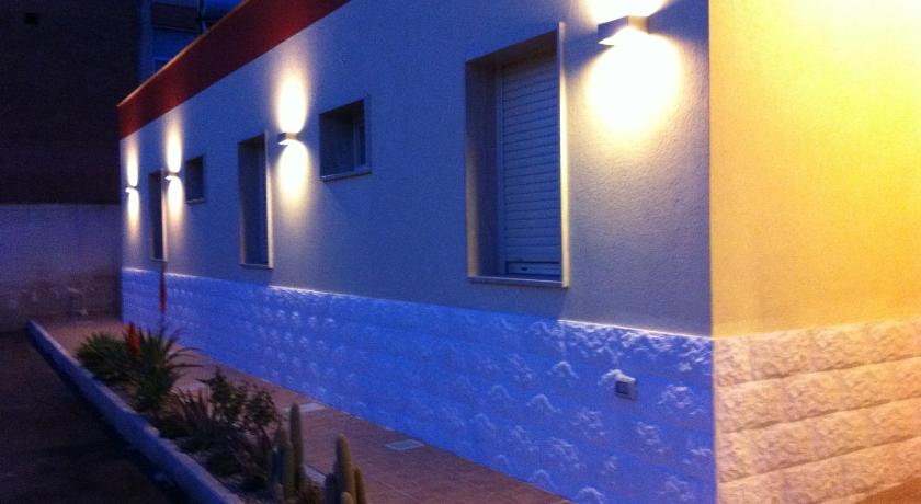 a blue and white building with a blue wall, Hotel Giardino in Modugno