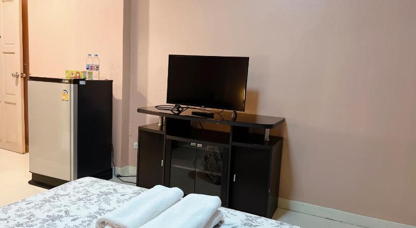 a room with a bed, desk and a television, Arada Boutique Place in Bangkok