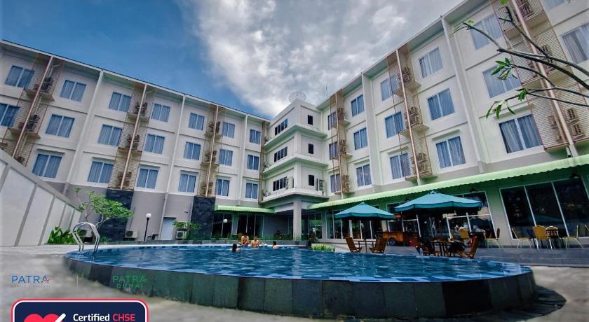 a large swimming pool in front of a building, Patra Dumai Hotel in Dumai
