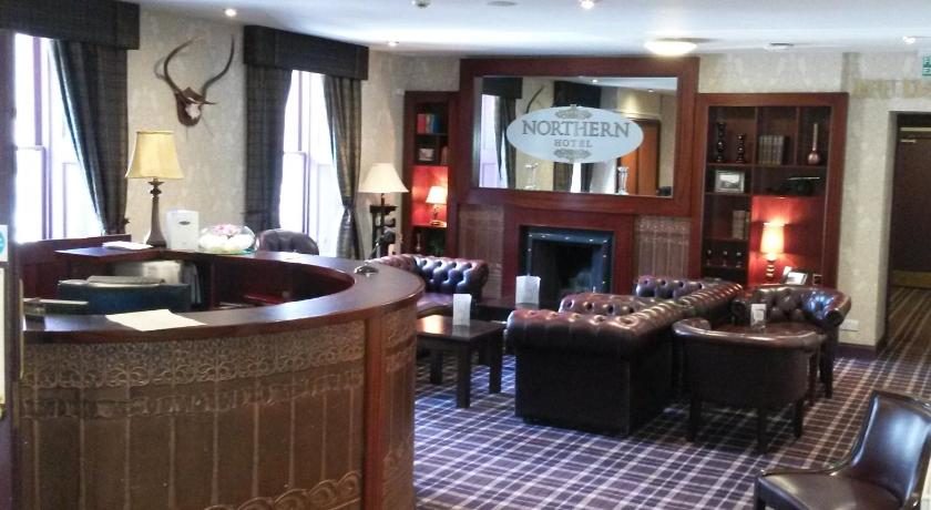 a living room filled with furniture and a fire place, Northern Hotel in Brechin