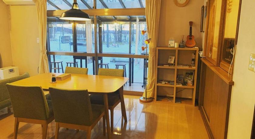a dining room table and chairs in a room, Guesthouse Akane-Yado (Adult Only) in Furano