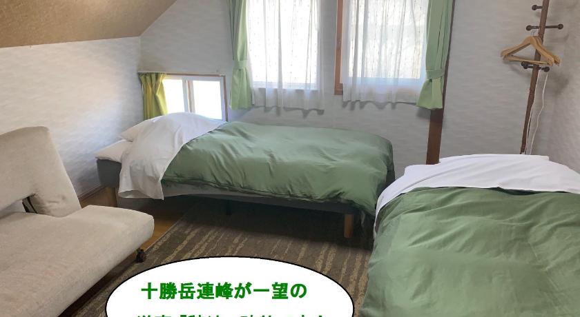 a bedroom with a bed, a desk and a window, Guesthouse Akane-Yado (Adult Only) in Furano