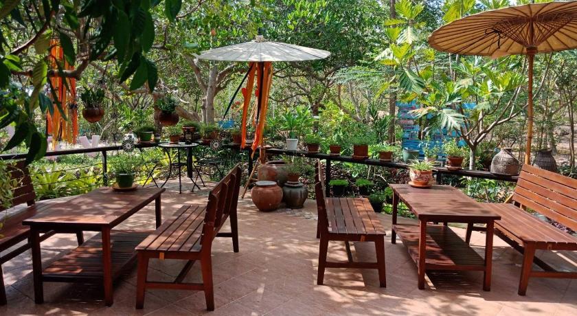 a patio area with tables, chairs and umbrellas, Farm Madame Fleur in Hua Hin / Cha-am