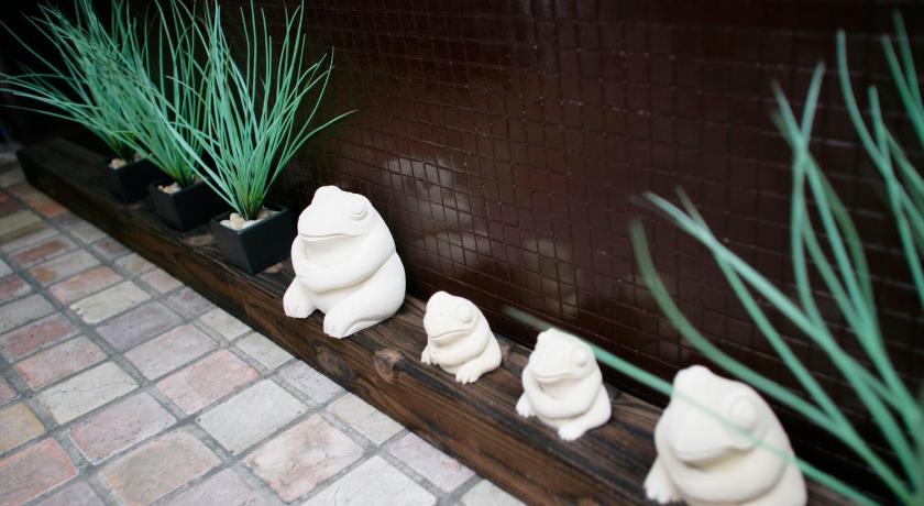 a row of white vases sitting on top of a wooden bench, HOTEL CHECK INN BALI adult only in Tokyo