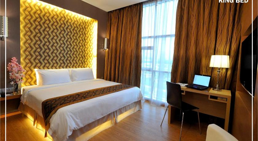 a hotel room with a bed and a desk, Courtyard Hotel in Kota Kinabalu