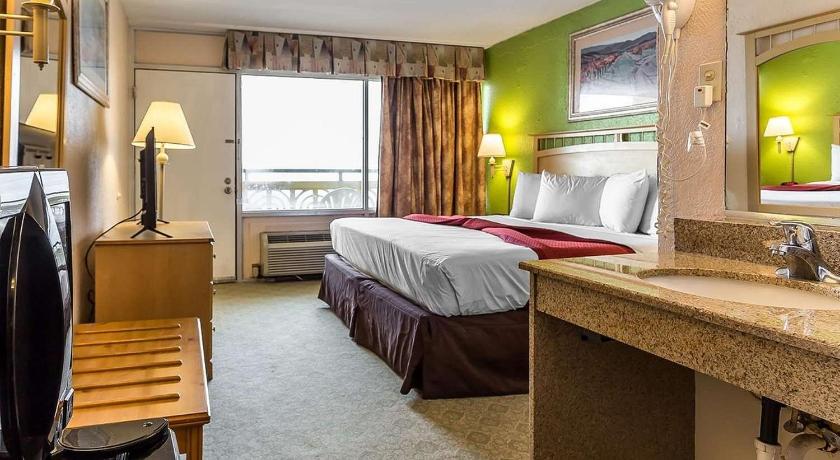 a hotel room with two beds and a tv, Ocean Star Hotel - Adults Only in Myrtle Beach (SC)