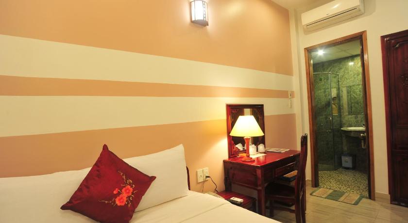 a bedroom with a bed and a desk, Hong Thien Ruby Hotel in Hue