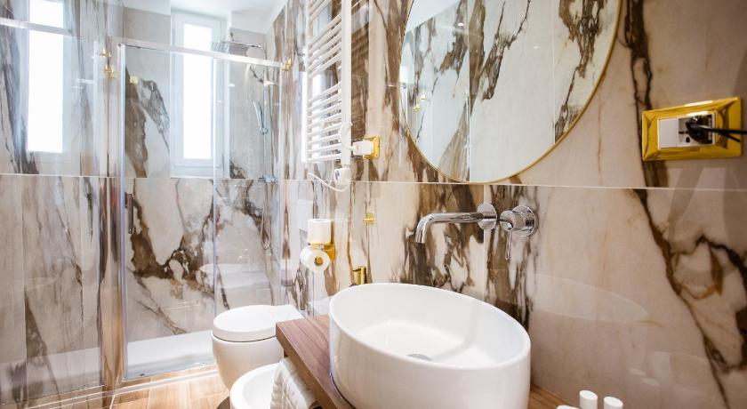 a bathroom with a toilet, sink, and bathtub, Atmosfere Guest House - Cinque Terre e La Spezia in La Spezia