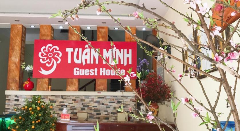 a sign on a table in front of a christmas tree, Tuan Minh Guest House in Dien Bien Phu
