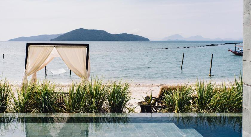 a patio with a view of the ocean, The Beach Samui  in Koh Samui